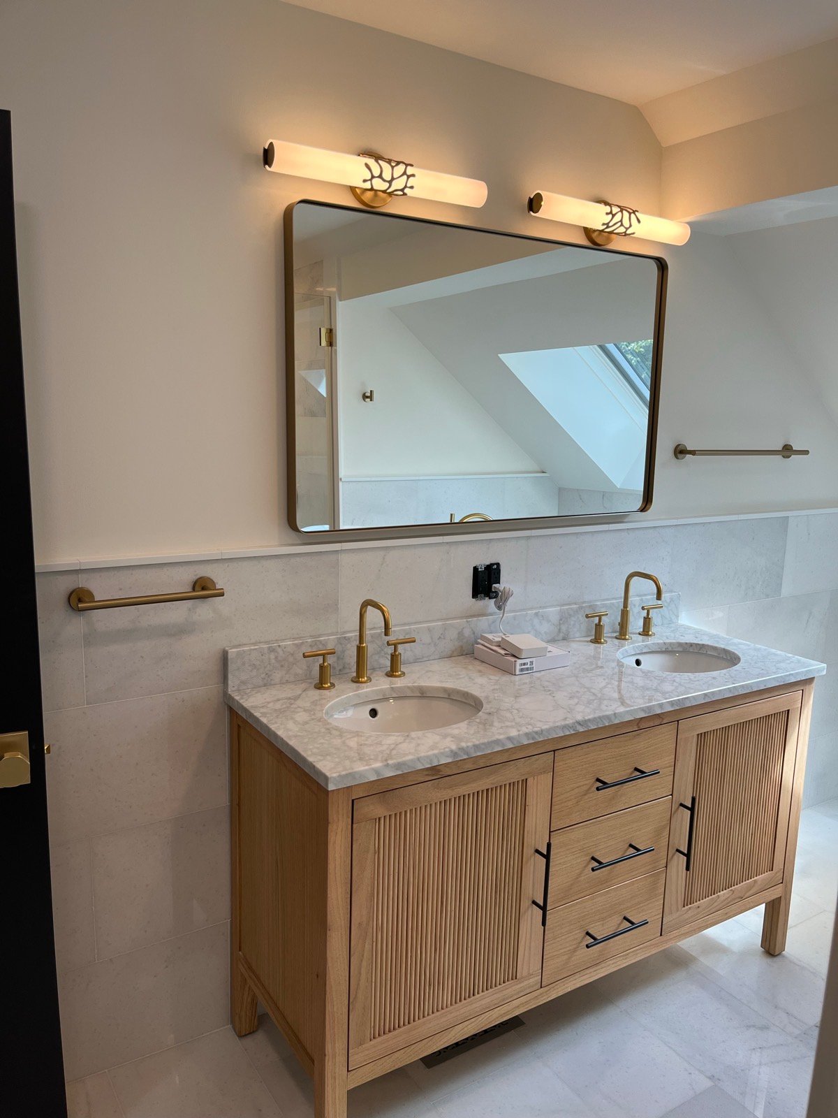 Finished bathroom vanity with brass fixtures