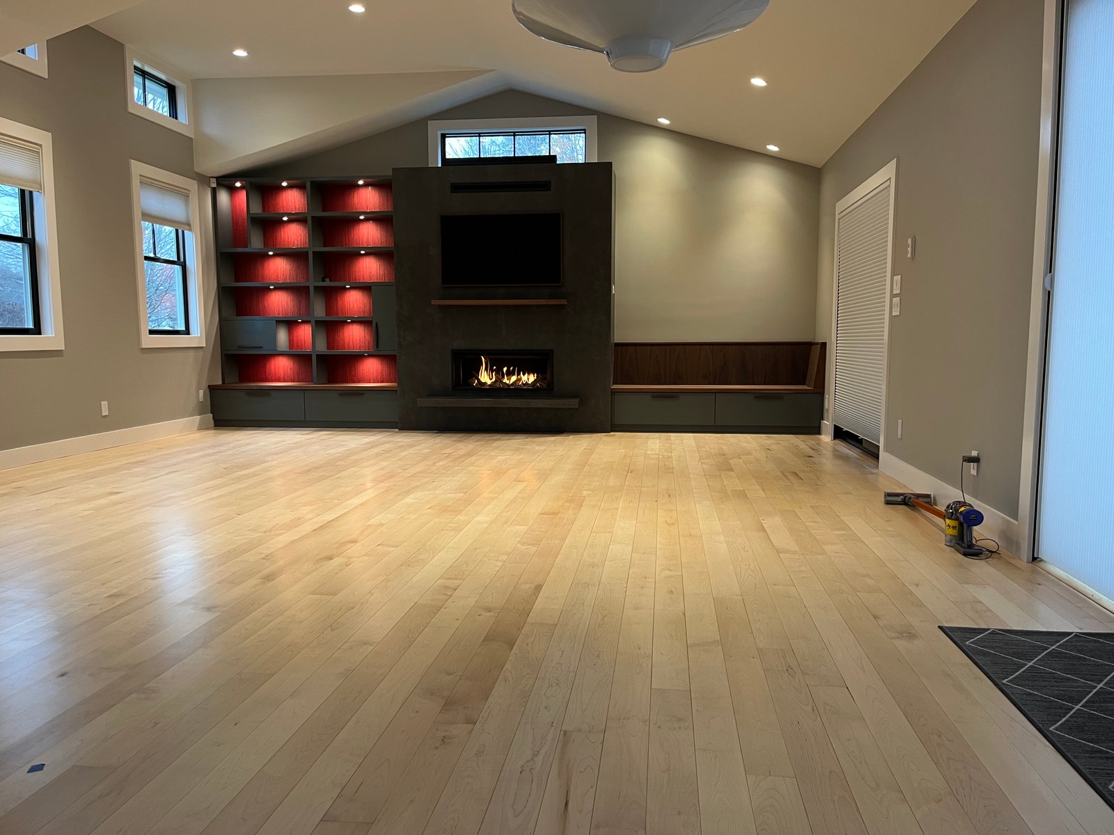 Finished living room with custom built-ins and fireplace